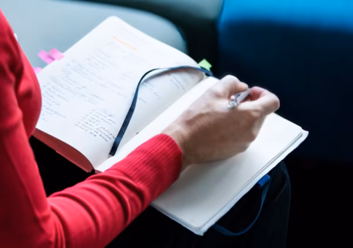 Woman writing in a notebook